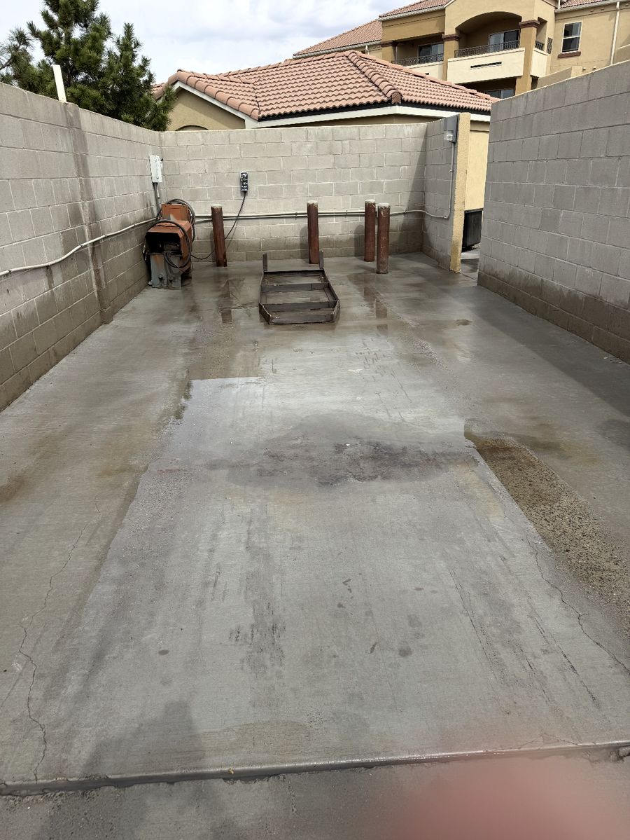 Same dumpster pad concrete cleaned and free of oil stains after pressure washing