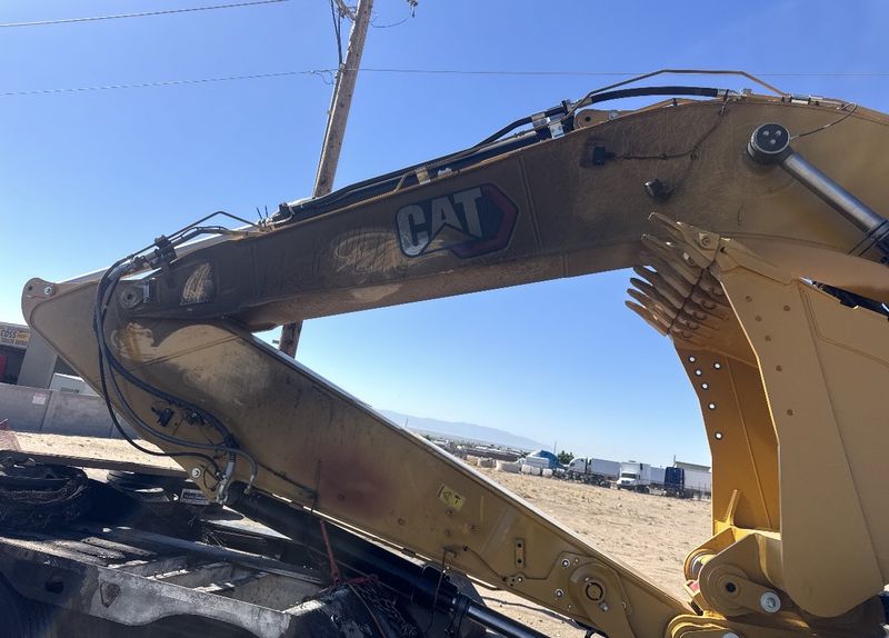 Excavator arm with dirt and grime on the paint before cleaning